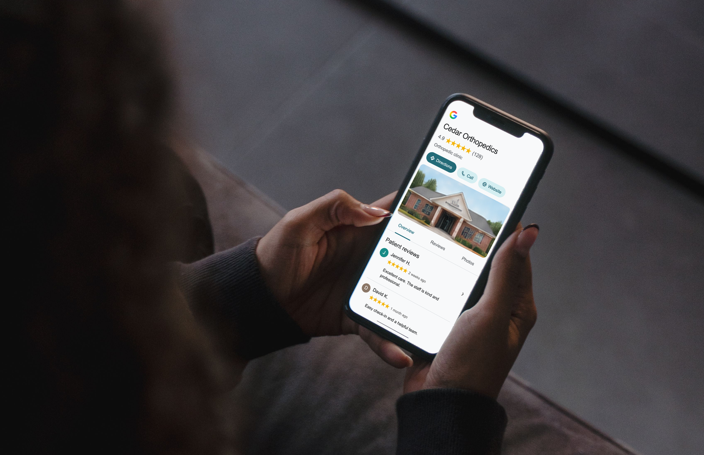 A person viewing the illustrative Cedar Orthopedics Google profile on their phone.